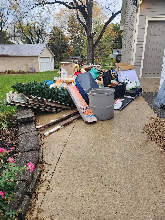Dumpster being loaded with debris for 12 Yard Dumpster Rental in Guthrie